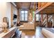 Open living area features exposed brick, a fireplace, wood beams, and modern decor with natural light at 170 Boulevard Se # 111H, Atlanta, GA 30312