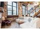 Inviting living room features exposed brick, large windows, and comfortable white sectional sofa at 170 Boulevard Se # 111H, Atlanta, GA 30312