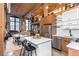 Spacious living area featuring exposed brick walls, wood beams, modern kitchen, and loft with stairs at 170 Boulevard Se # 111H, Atlanta, GA 30312