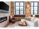 Cozy living room with fireplace, exposed brick, and comfortable seating arrangement at 170 Boulevard Se # 111H, Atlanta, GA 30312