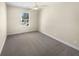 Bedroom with a large window and plush carpeting at 1740 Berry Ct, Cumming, GA 30041