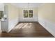 Dining room with wood-look flooring, white trim, and a large window overlooking the yard at 1740 Berry Ct, Cumming, GA 30041