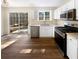 Modern kitchen with stainless steel appliances, granite countertops, a breakfast bar, and natural light at 1740 Berry Ct, Cumming, GA 30041