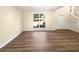 Bright living room with wood-look flooring, and white trim, bathed in natural light from a large window at 1740 Berry Ct, Cumming, GA 30041