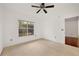 Light bedroom featuring neutral carpet, ceiling fan and large window at 2700 Pine Tree Ne Rd # 3010, Atlanta, GA 30324