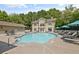 Community pool with lounge chairs and seating area surrounded by trees at 2700 Pine Tree Ne Rd # 3010, Atlanta, GA 30324