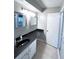 Cozy bathroom with dark counters, white cabinets, and neutral tile floors at 3020 Wingate Way, Sandy Springs, GA 30350