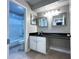 Cozy bathroom with dark counters, white cabinets, and a shower-tub combo at 3020 Wingate Way, Sandy Springs, GA 30350