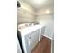 Clean laundry room with wire shelving and modern washer and dryer units with wood flooring at 3020 Wingate Way, Sandy Springs, GA 30350