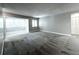 A brightly lit living room featuring neutral walls, carpet, and a sunroom at 3020 Wingate Way, Sandy Springs, GA 30350