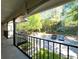 Exterior balcony view showcasing mature trees, landscaped areas, and assigned parking at 3020 Wingate Way, Sandy Springs, GA 30350