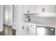 Close up of the bar featuring white cabinetry, black hardware, and stainless steel fridge at 320 Gray Shingle Ln, Woodstock, GA 30189