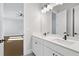 Bright bathroom with double sinks, stone countertops, and modern lighting at 320 Gray Shingle Ln, Woodstock, GA 30189