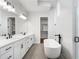 Bright bathroom featuring double vanity, modern fixtures, soaking tub, and walk-in shower at 320 Gray Shingle Ln, Woodstock, GA 30189