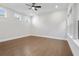 Bright bedroom with a ceiling fan, three windows, and hardwood floors for a cozy feel at 320 Gray Shingle Ln, Woodstock, GA 30189