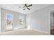 Light-filled bedroom with balcony access, a ceiling fan, and neutral decor at 320 Gray Shingle Ln, Woodstock, GA 30189