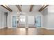 Bright dining room with hardwood floors, exposed beams, and access to the outdoor patio through sliding glass doors at 320 Gray Shingle Ln, Woodstock, GA 30189