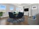 Bright game room with game table, hardwood floors, blue accent rug, and wall mounted TV at 320 Gray Shingle Ln, Woodstock, GA 30189