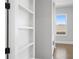 Hallway with built-in shelving and stylish trim, offering both functionality and aesthetic appeal to the home's interior at 320 Gray Shingle Ln, Woodstock, GA 30189