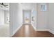 Bright hallway leading to a door with glass, complemented by natural light and hardwood floors at 320 Gray Shingle Ln, Woodstock, GA 30189