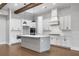 Modern kitchen with white cabinets, a gray island, pendant lighting, stainless steel appliances, and hardwood flooring at 320 Gray Shingle Ln, Woodstock, GA 30189