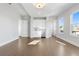 Spacious living room featuring a built in bar, stainless steel refrigerator, and hardwood floors at 320 Gray Shingle Ln, Woodstock, GA 30189