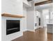 Living Room featuring a modern electric fireplace and a view of the kitchen with white cabinets and stainless appliances at 320 Gray Shingle Ln, Woodstock, GA 30189