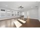 Sun-filled living room with gleaming hardwood floors, recessed lighting, and staircase access, exuding warmth and sophistication at 320 Gray Shingle Ln, Woodstock, GA 30189