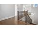 Elegant staircase with wooden railing, iron spindles, and hardwood floors leading upstairs at 320 Gray Shingle Ln, Woodstock, GA 30189