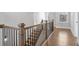 Beautiful staircase featuring wooden steps and black iron railings, connecting different levels of the home with style and elegance at 320 Gray Shingle Ln, Woodstock, GA 30189