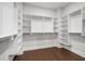 Spacious walk-in closet with custom shelving and hardwood floors at 320 Gray Shingle Ln, Woodstock, GA 30189