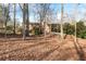 Expansive leafy backyard view showing the side exterior elevation and multi-car driveway at 3640 Shelby Ln, Marietta, GA 30062