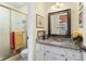 Cozy bathroom features marble countertop, framed mirror and a walk-in shower at 3640 Shelby Ln, Marietta, GA 30062