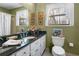 Bathroom features a large mirror, black granite countertop and white wood cabinets at 3640 Shelby Ln, Marietta, GA 30062