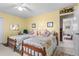 Bright yellow bedroom features twin beds, ceiling fan and floral decorations at 3640 Shelby Ln, Marietta, GA 30062