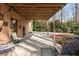 Covered back patio leading to the driveway with comfortable chairs and a cozy atmosphere at 3640 Shelby Ln, Marietta, GA 30062