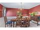 Elegant dining room with traditional furnishings, chandelier, and red accent wall at 3640 Shelby Ln, Marietta, GA 30062