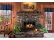 Charming stone fireplace with wood-burning insert, complemented by rustic wood paneling at 3640 Shelby Ln, Marietta, GA 30062