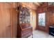 Inviting foyer featuring wood paneling, vintage secretary, and a decorative stained glass front door at 3640 Shelby Ln, Marietta, GA 30062