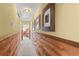 Hallway with wood-paneled lower walls and framed artwork leading to another room at 3640 Shelby Ln, Marietta, GA 30062