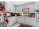 Well-lit kitchen featuring white cabinets, granite countertops, and stainless steel appliances at 3640 Shelby Ln, Marietta, GA 30062