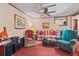 Cozy living room with comfortable seating, ceiling fan, and bright natural light from the window at 3640 Shelby Ln, Marietta, GA 30062