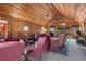 Inviting living room with wood-paneled walls, vaulted ceilings, and a cozy stone fireplace at 3640 Shelby Ln, Marietta, GA 30062