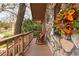 Charming porch featuring a rustic stone wall, rocking chairs, and a view of the serene, tree-lined neighborhood at 3640 Shelby Ln, Marietta, GA 30062