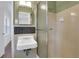 A retro bathroom displays a tiled shower, vintage-style sink, and black-and-white hexagon tile at 4169 Cedar Valley Ln, Conley, GA 30288