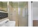 A retro bathroom displays a tiled shower, vintage-style sink, and black-and-white hexagon tile at 4169 Cedar Valley Ln, Conley, GA 30288