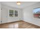 A well-lit bedroom with hardwood flooring and a view of the outdoors offers a bright and inviting space at 4169 Cedar Valley Ln, Conley, GA 30288