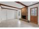 Living room with brick fireplace, exposed wood beams, tile floor, and access to the outdoors at 4169 Cedar Valley Ln, Conley, GA 30288