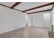 Bright living room with tile flooring, exposed beams, and a view into adjacent rooms at 4169 Cedar Valley Ln, Conley, GA 30288