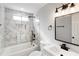 Sleek bathroom featuring marble-look tile, black hardware, a modern vanity, and large soaking tub at 190 Clydesdale Se Ln, Mableton, GA 30126